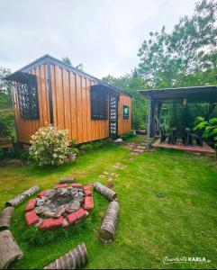 a backyard with a house and a fire pit at Cabinscape - Albay in Malilipot