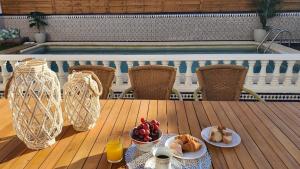a table with food on it next to a swimming pool at Villa Gení La Victoria by Ruralidays in La Victoria