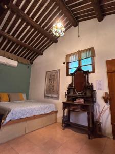 a bedroom with a bed and a mirror and a table at 緩緩歸 Slow living in Anping