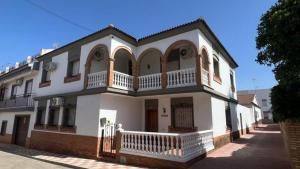 a large white house with a balcony on a street at Villa Gení La Victoria by Ruralidays in La Victoria