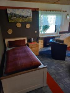 a bedroom with a bed and a large window at Monteur- und Ferienwohnung Waldrauschen in Fehrenbach