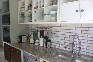 a kitchen with a sink and a counter top at Newly furnished cozy house next to the beach in Calafell