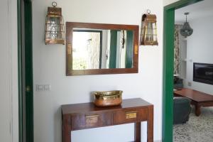una habitación con espejo y una mesa con un tazón. en Newly furnished cozy house next to the beach en Calafell