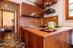 a kitchen with wooden cabinets and a counter top at Villa Diamanti in Monemvasia