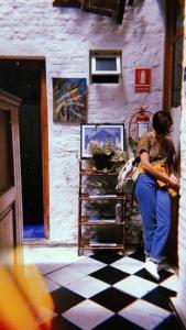 a woman standing in front of a building at casa vegana in Montevideo