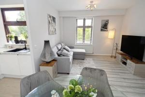a living room with a couch and a table at Modern Watford Urban Luxury Oasis in Leavesden Green