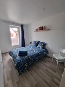 a bedroom with a bed and a chair and a window at Appartement centre ville Rixheim in Rixheim