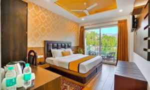 a bedroom with a bed and a balcony at Dalhousie View Resort in Dalhousie