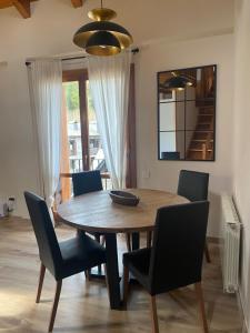 a dining room table with chairs and a table and a mirror at Duplex Kasares en Sesué No VU HUESCA24037 in Sesué