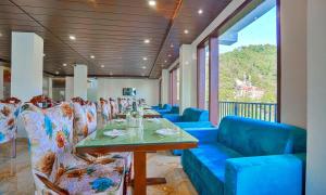 a dining room with a long table and chairs at Dalhousie View Resort in Dalhousie