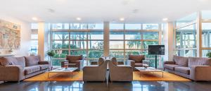 a large living room with couches and a tv at Hotel Air Penedès in Vilafranca del Penedès