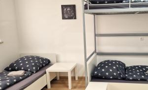 a room with two bunk beds and a table at Sson-Appartments in Detmold