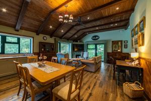 a living room with a table and chairs and a couch at Black Sheep Hotels Cabins in Spean Bridge