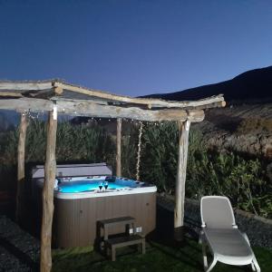 a hot tub in a gazebo with a chair at Casa Guerepe in La Pared