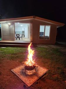 a fire pit in a yard in front of a house at 40 On North. in Wandoan