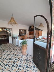 a kitchen with a potted plant sitting on a floor at La Maison des Vagues in Sidi Kaouki