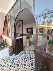 an open door into a room with a tile floor at La Maison des Vagues in Sidi Kaouki