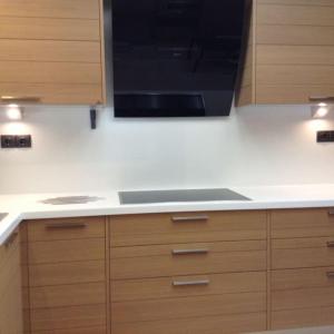 a kitchen with a black microwave and wooden cabinets at Luxury Floor Apartment with Private Pool in Drafí