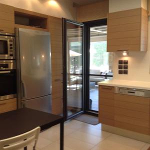 a kitchen with a refrigerator and a table in it at Luxury Floor Apartment with Private Pool in Drafí