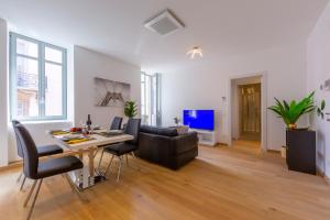 a living room with a table and a couch at Heart of Lugano - Happy Rentals in Lugano