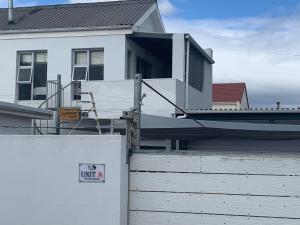 a boat sitting on top of a house at OysterCatcher Self-Catering Accommodation Strand in Cape Town