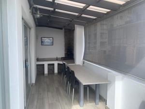 a dining room with a table and chairs at OysterCatcher Self-Catering Accommodation Strand in Cape Town