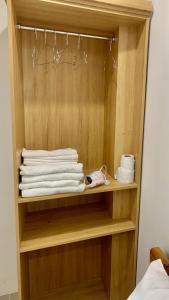 a wooden cabinet with towels and towels at KHÁCH SẠN GIA HÒA 3 in Vung Tau