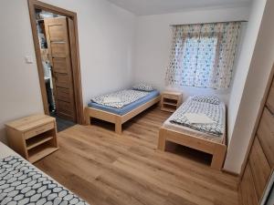 ein kleines Zimmer mit 2 Betten und einem Fenster in der Unterkunft family cottage in Senica