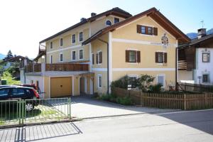 a house with a car parked in front of it at Haus Schmiedhofer in Villabassa