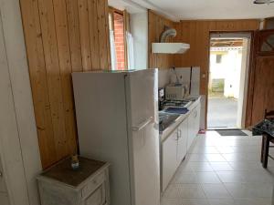 una cucina con frigorifero bianco in una camera di Ducey-Les Chéris étape Mont Saint Michel St Malo 50220 a Ducey