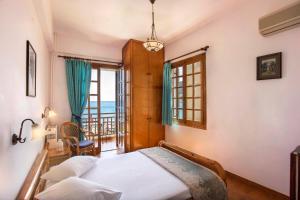 a bedroom with a bed and a view of the ocean at Villa Diamanti in Monemvasia