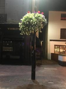 a bouquet of flowers sitting on top of a pole at Ocean Breeze 5 minutes walk to the beach - Free Parking in Lancing