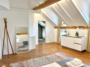 a kitchen with white cabinets and a sink in a room at Historic Rooms and Apartments in the City Centre of Bolzano in Bolzano