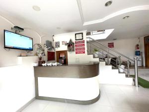 a hospital lobby with a staircase and a tv at HOTEL PRINCE ! NAINITAL Mall Road-prime-location in-front-of-Naini-lake hygiene-and-spacious-room in Nainital