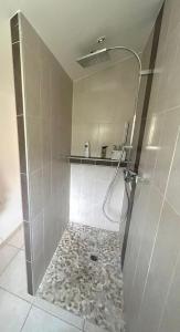 a bathroom with a shower with a stone floor at La pause en luberon in Cavaillon +20 photos