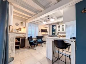 a kitchen with chairs and a counter in a room at Les Dames YourHostHelper in Gières