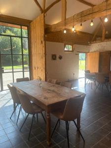 een grote eetkamer met een houten tafel en stoelen bij Art Of Einstein in Diest