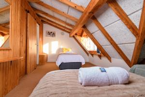 a bedroom with two beds in a attic at Zi Wu Self Catering Apartment in Swakopmund