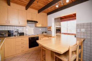 a kitchen with a wooden table and a counter top at Zi Wu Self Catering Apartment in Swakopmund