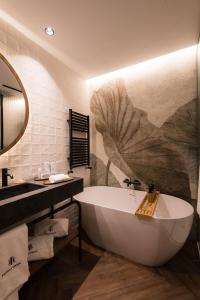 a bathroom with a tub and a large flower mural at Castilla Termal Brihuega in Brihuega