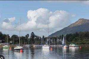 a bunch of boats in a body of water at A charming luxury apartment! in Portinscale