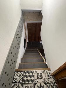 a staircase with black and white tiled floors at logement atypique Menton in Menton