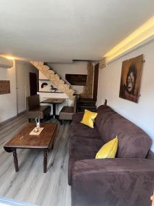 a living room with a couch and a table at logement atypique Menton in Menton