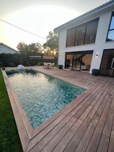 a swimming pool in front of a house at Villa haut standing avec piscine in Gradignan