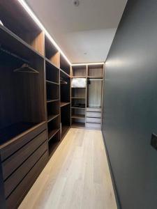 a walk in closet with wooden shelves at Villa haut standing avec piscine in Gradignan