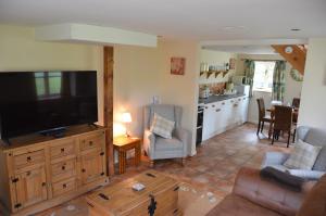 a living room with a large flat screen tv at Hafannedd in Corwen