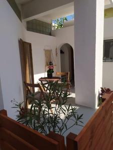 a patio with a table and chairs in a house at New studio in the city! in Kos Town