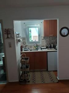 a small kitchen with a sink and a window at New studio in the city! in Kos Town