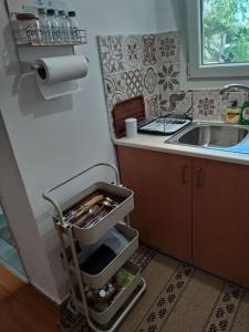 a small kitchen with a sink and a cart at New studio in the city! in Kos Town