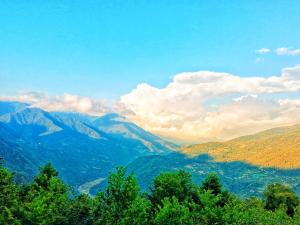 a view of a mountain valley with trees and clouds at Zesopheli guest house in Keda Agro & Eco tourism in Zesop'eli